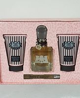 Full set including tubes, perfume bottle with charm, and small spray vial in branded packaging