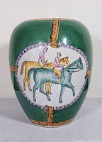 Full view of the vintage ceramic ginger jar vase showing the green background and front medallion with horses and riders
