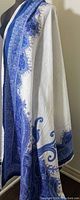 Dupatta draped on a mannequin showing the blue and white paisley patterns and borders.