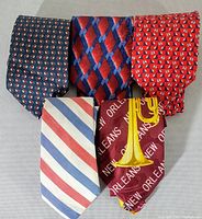 Front view of five vintage ties showing various patterns and colors.