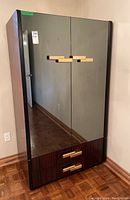 Front view of Modernindustria veneer armoire with mirrored doors and two drawers at bottom