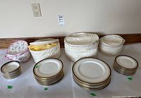 Overall lot: bowls and plates in stacks with three quilted storage cases