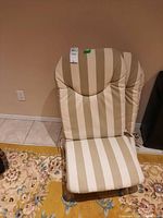 Single striped chair cushion with tags, front view showing contour design, beige and off white wide stripes.