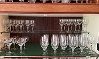 Three-shelf display of full lot: coupes, wine glasses and water goblets