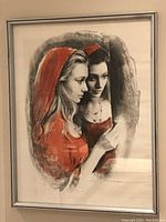 Full view of framed limited edition print showing two women in red hoods, depicting artistic black, gray, and red palette.