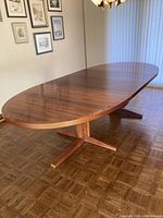 Full view of oval tabletop and twin pedestal base