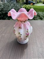 Front view of the pink Rosalene melon-shaped vase with ruffled edge and handpainted roses and gold leaf details down the ribs.
