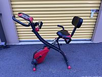 Full side view of the Fitnation exercise bike showing frame, seat, pedals, and digital display.