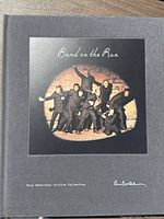Front cover of the hardcover book showing the 'Band on the Run' album cover photo and Paul McCartney signature.