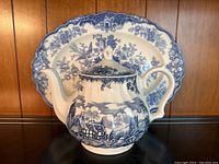 Blue and white China teapot with Willow pattern and 23 karat gold accents on rim, handle, and lid.