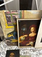 Photo of two portraits showing a classical woman in red dress with a bird and an abstract colorful painting