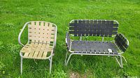 Front view of beige single chair and black loveseat chair on grass.