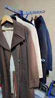 Five overcoats on rack showing entire lot