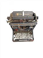 Front view of antique Underwood typewriter showing keyboard, brand logo, and paper holder