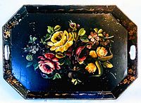 Full view of the large tole ware tray showing black background with painted floral bouquet and octagonal shape with handles.