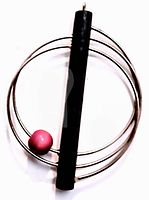 Front view of the mid century modern pendant showing three concentric rings, central black rod, and pink bead near the rod.
