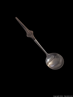 Full view of mid century serving spoon with metal scoop and wood handle.