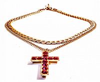 Full view of gold-tone double strand necklace with cross pendant with red stones