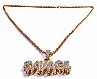Front view of the gold-tone twisted chain necklace with rhinestone-encrusted 'SAVAGE' pendant, showing full length of chain and pendant detail.
