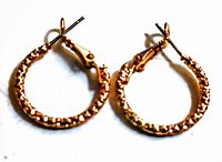 Pair of vintage rhinestone pierced hoop earrings with gold-tone metal and rhinestones.