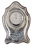 Front view of vintage desk clock with polished hammered sterling silver frame and floral embossing.