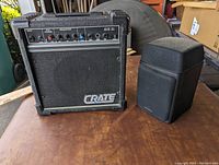 Crate G15 XL guitar amplifier and black standalone speaker side by side.
