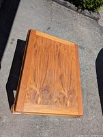Top down view showing the wood grain and rectangular shape of the table top.