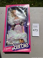 Front view of boxed Crystal Barbie doll showing holographic dress and box art.