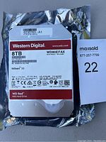 Front label of Western Digital 8TB NAS hard drive with technical specifications and model details.