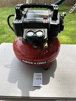 Front view showing tank, handle, pressure gauges, and on/off switch on top housing.