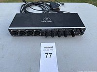 Front view of the Behringer U-PHORIA UMC404HD audio interface showing input jacks, control knobs, and brand logo.