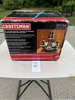 Box front showing product image, brand, and features of the grinder.