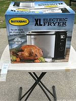 Front side of the Butterball XL Electric Fryer box showing model and food image.