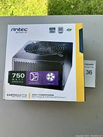 Photo of boxed Antec EarthWatts 750W power supply unit showing front with power rating, features and branding.