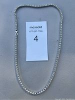 Full view of the necklace laid out flat showing its full length and clasp.
