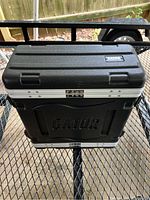 Top view of closed black Gator hard case with silver clasps and latch.