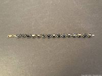 Full length view of bracelet on dark background