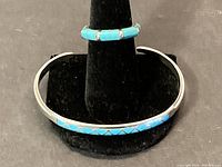 Bracelet and ring displayed together on black background