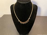 Full-view of vintage Sherman necklace on black bust form, showing overall design and necklace length.