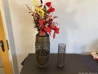 Overview of floor vase with silk flowers and metal lattice vase