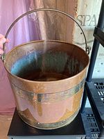 Copper bucket showing exterior finish and metal bands