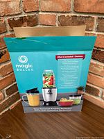 Magic Bullet original box showing branding, an image of the blender, and list of included components