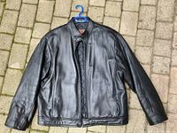 Front view of the men's Danier black leather jacket showing the smooth leather exterior and bomber style cut.