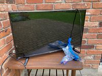 RCA Scenium 29 inch flat screen TV placed on a wooden table outdoors, with power cord attached.