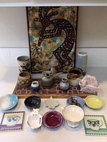 Overview of the lot showing all ceramic bowls, pots, candle holder, vases, and two wood pieces with tile Kokopelli design