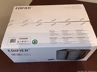 Box top of Edifier R1280T multimedia speakers showing packaging with brand and model info.