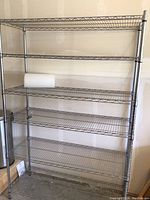 Full frontal view of the stainless steel shelving unit showing its width and height and the wire rack design.