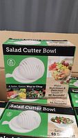 Photo of Salad Cutter Bowl boxed product showing front packaging with image of the product, BPA free label, and salad preparation benefits.