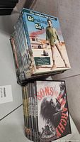 Photo showing stacked Breaking Bad complete box sets and Sons of Anarchy box sets, highlighting the cover art and condition of packaging.