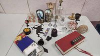 Full overview of the collectibles and knickknacks lot on a table showing all visible items.